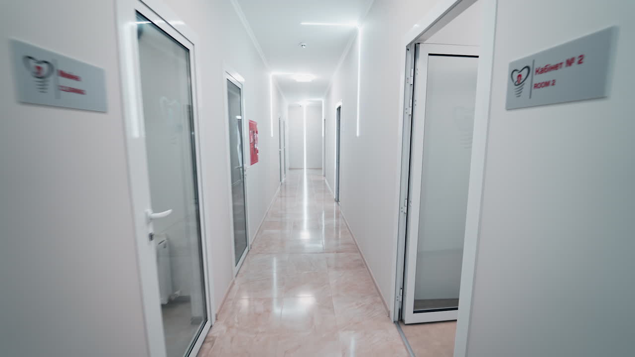Corridor in modern clinic. Long hospital bright corridor with rooms