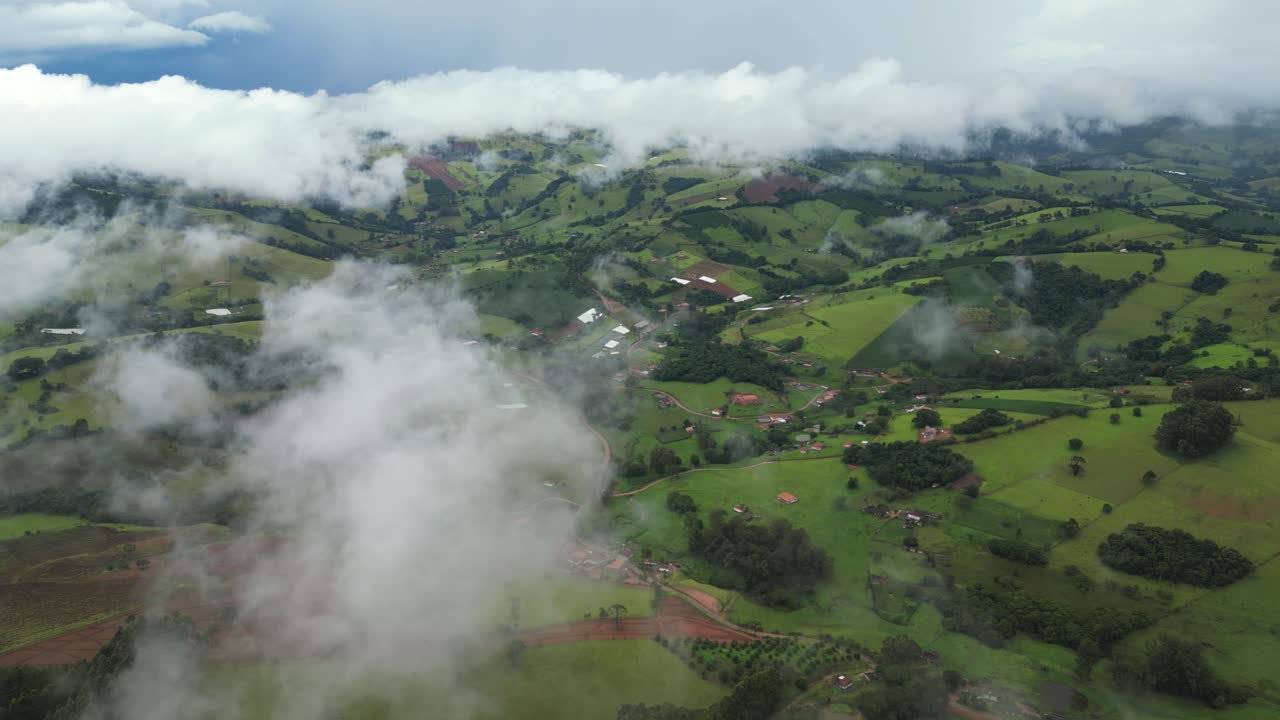 aerial panoramic view of a range of mountains of Minas Gerais during a a dense foggy day with a blue sky - Mist day in the hills - Minas Gerais, Serra da Mantiqueira - Brazil