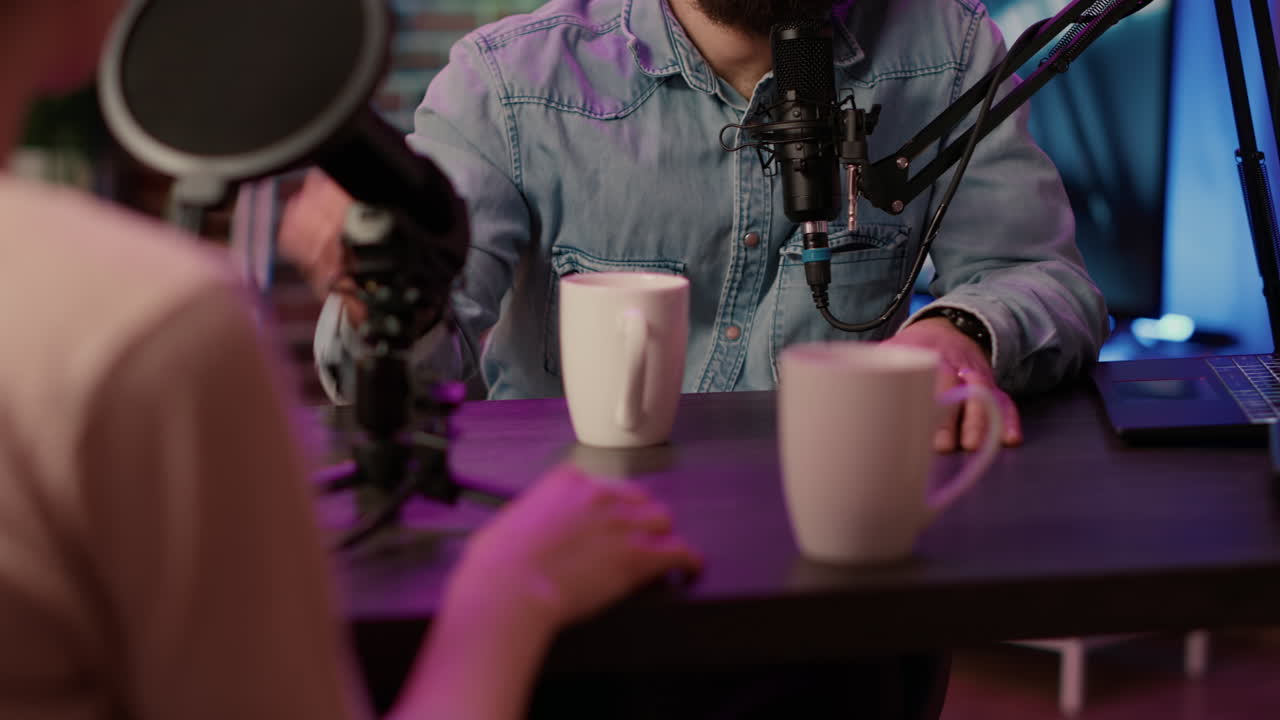 Closeup of online radio station host recording podcast interview with guest in online talkshow