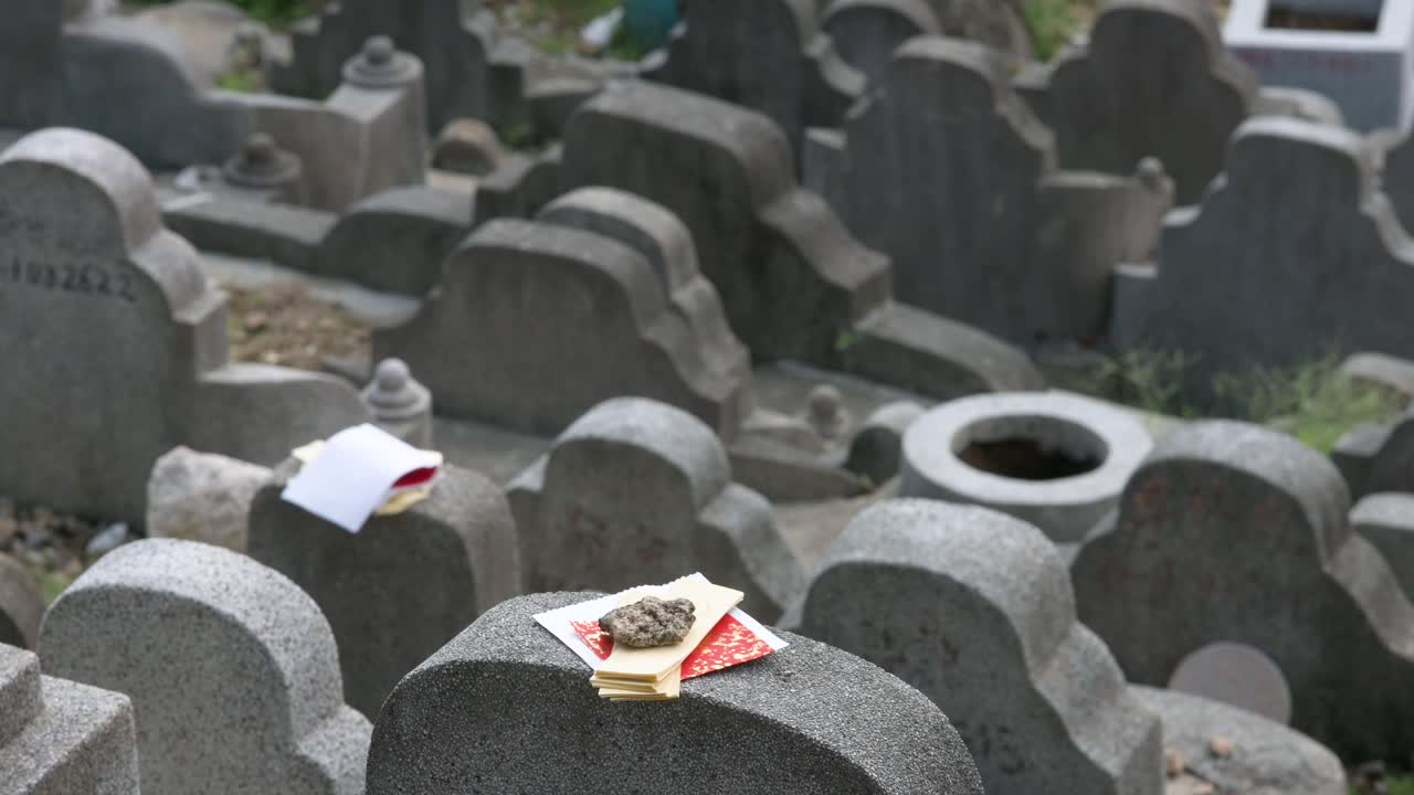 During the Chung Yeung Festival, an offering lays on top of a tombstone at the Diamond Hill cemetery as citizens visit deceased relatives' graves and bring offerings in remembrance and respect
