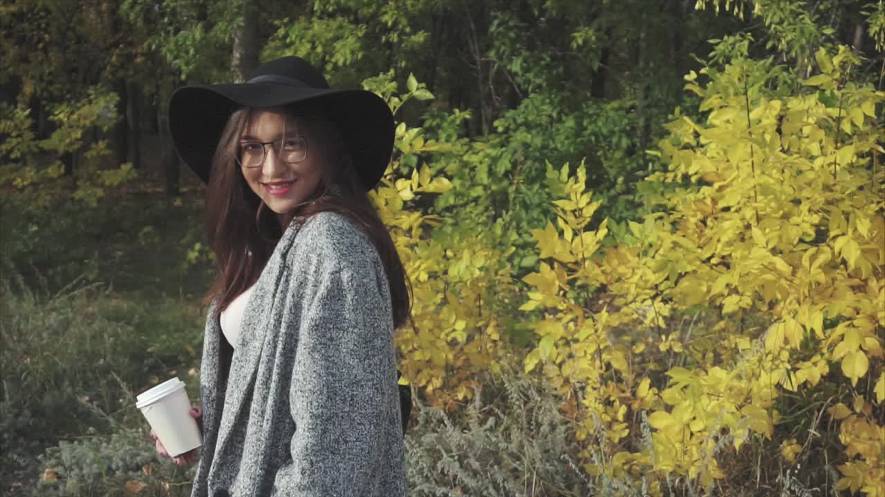 Woman enjoying coffee in autumn park