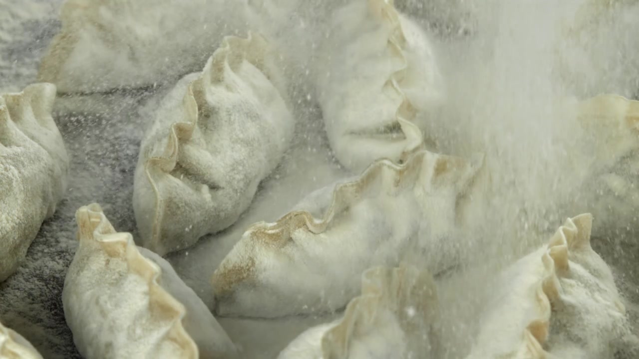 Flour Being Sprinkled on Freshly Made Dumplings
