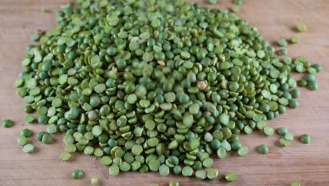 green peas fall on top of the table. high-protein legumes, beans and lentils for a healthy diet