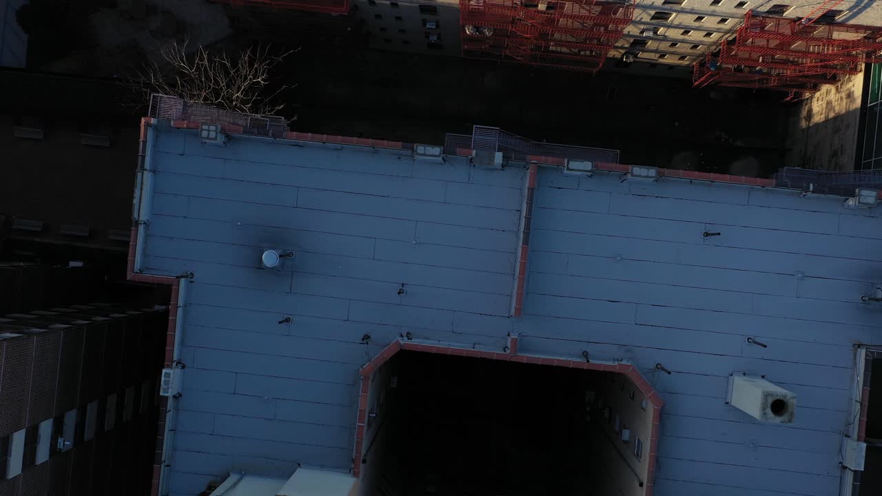 downward facing aerial rise over an apartment building in the Harlem neighborhood of New York City