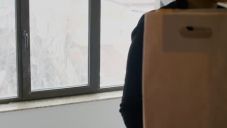 entrepreneur woman climbing stairs in startup company office holding takeaway food meal order