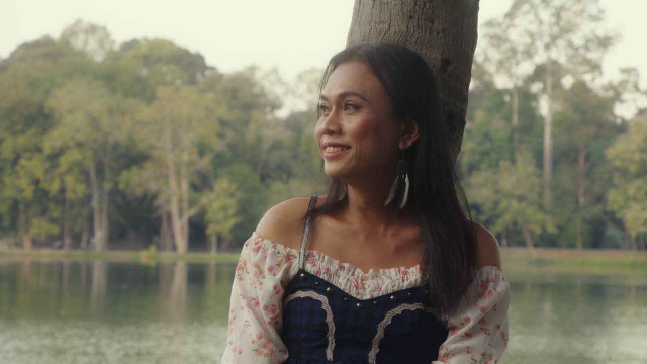 Woman Relaxing in a Park by the Lake