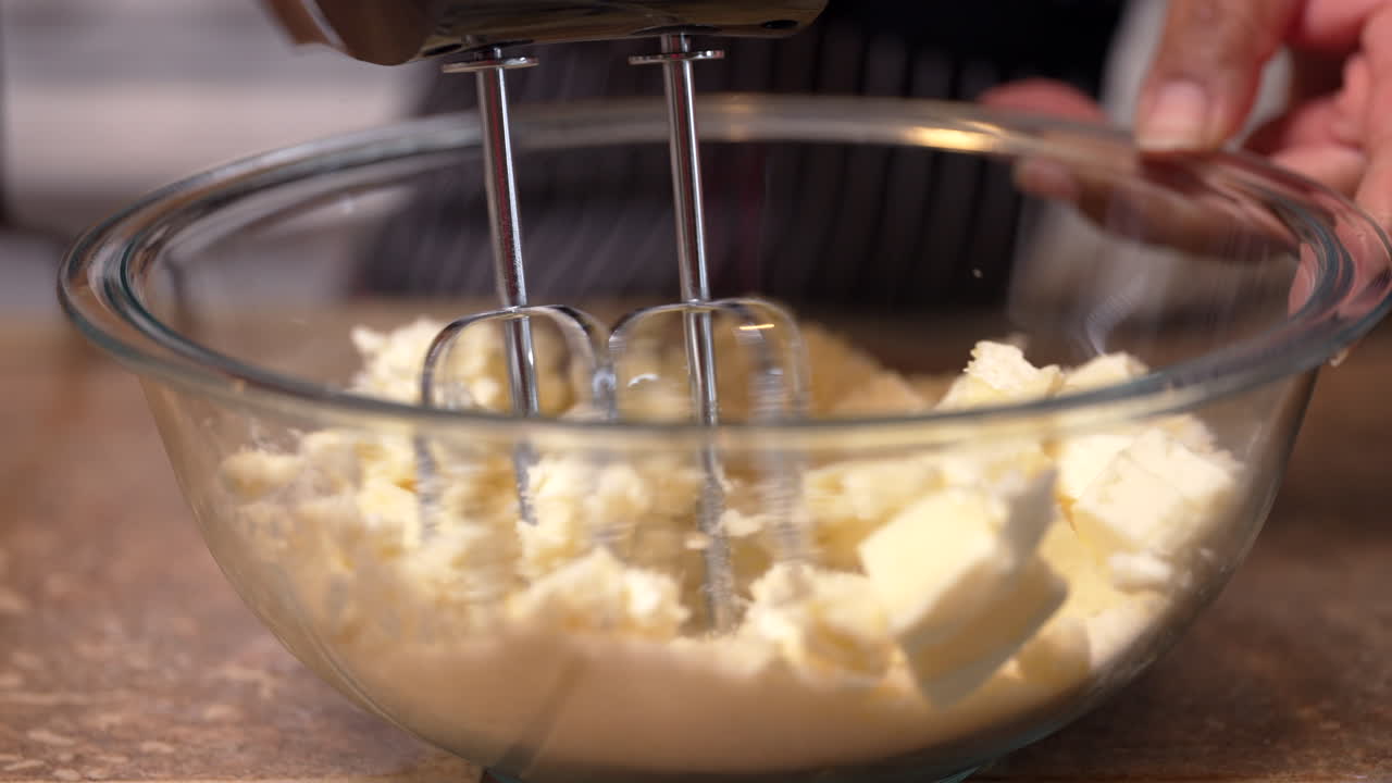 Mixing butter in with some of the dry ingredients for cake batter - isolated close up