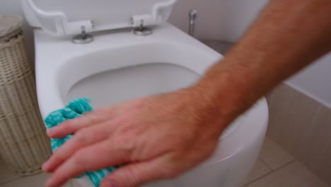 cleaning white toilet bowl ready for next guests