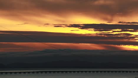 sunset along the straight low section of astoria megler bridge oregon to washington