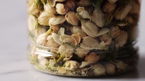 dried jasmine flowers in a jar