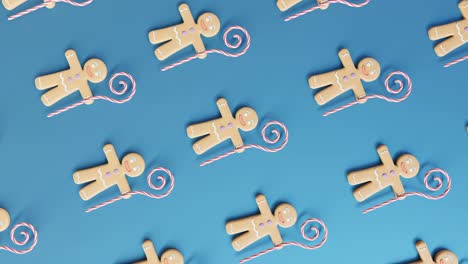 gingerbread men and candy canes on a blue background vertical