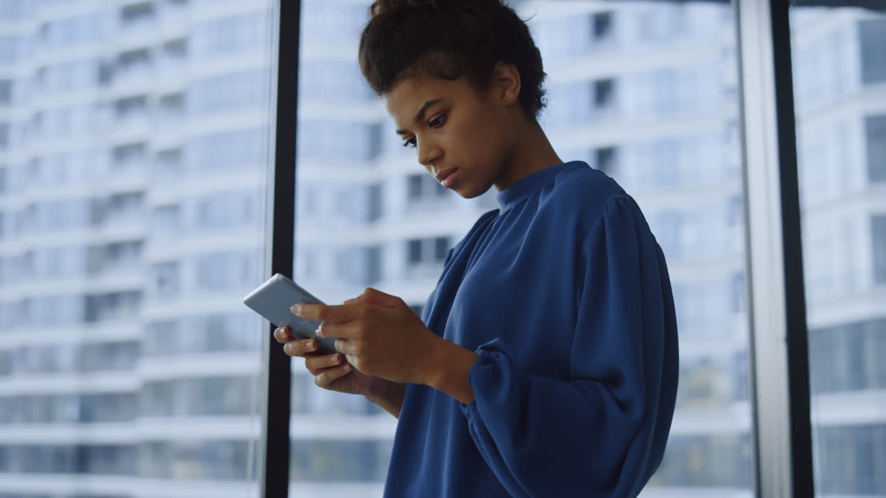 Business woman using tablet computer at office window. Top manager surfing