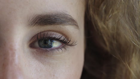 close up woman blue eyes pensive contemplative turning looking at camera wearing makeup vision aware