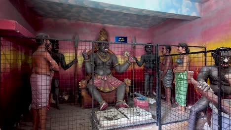 intricately detailed statues illustrating a buddhist representation of hell, located in a temple in negombo, sri lanka, showcasing cultural and religious artistry.