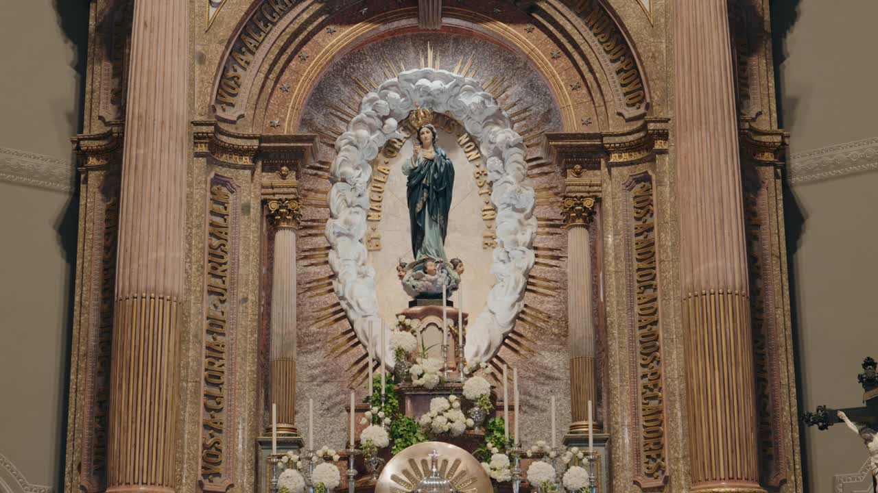 detailed church altar featuring virgin mary and white hydrangeas in daylight