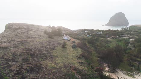 aerial view orbit of the village on the mountain in bãi tắm hòn choi in the morning.