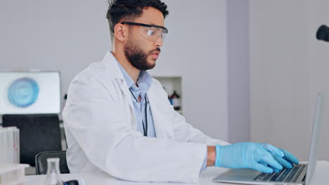 Adult-male-scientist-working-on-laptop