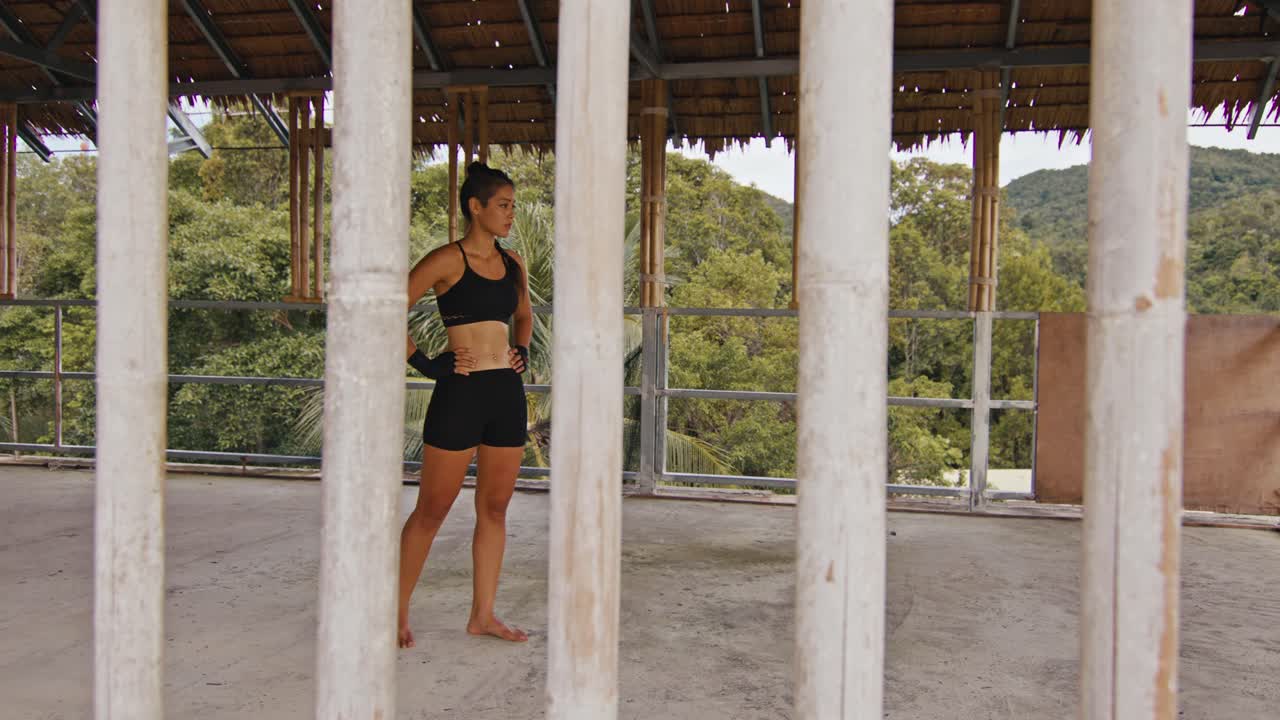 Woman Training Outdoors in a Bamboo Hut