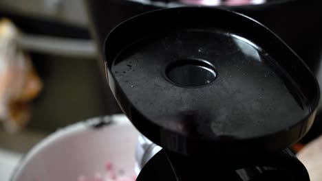 making pork mince with the electric meat grinder in the kitchen