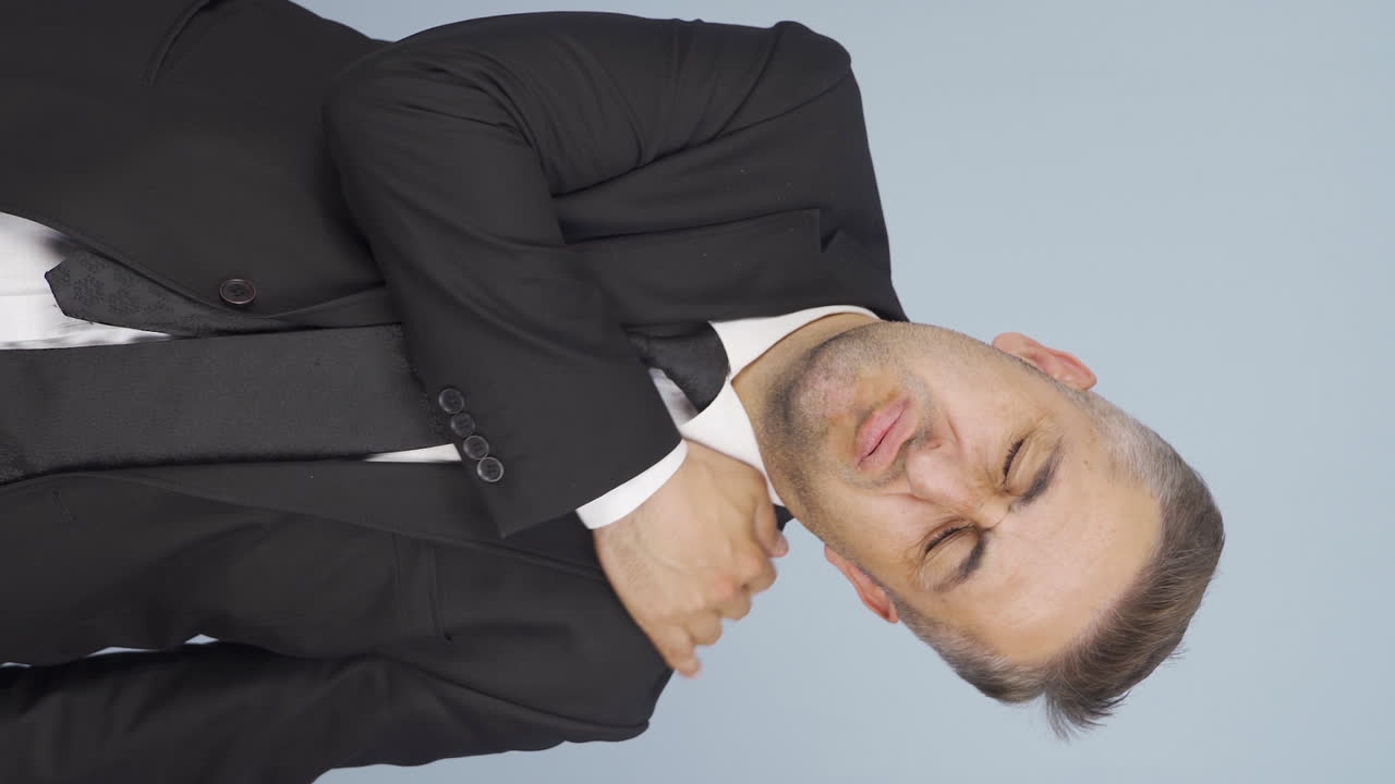 Vertical video of Businessman's shoulders hurt.
