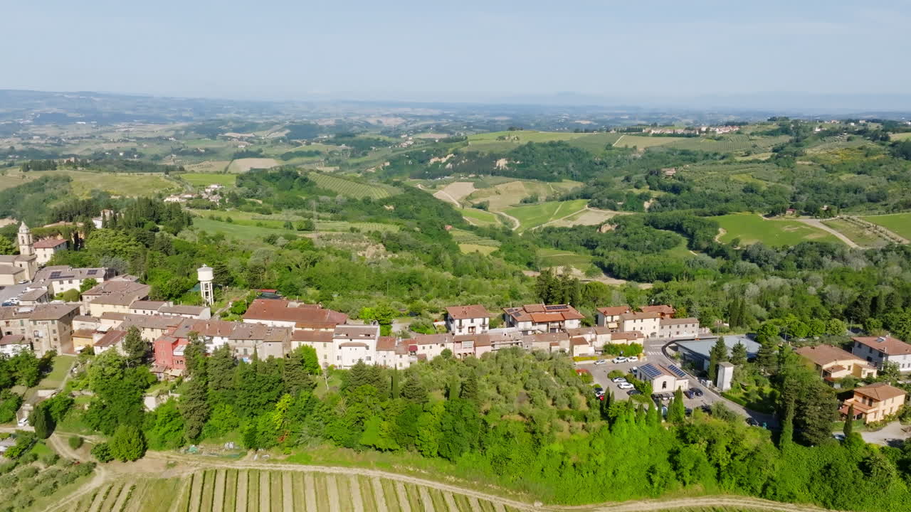 Aerial tracking shot in front of the Marcialla village, summer in Tuscany, Italy