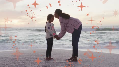 Animation-of-christmas-stars-over-biracial-mother-and-daughter-on-beach