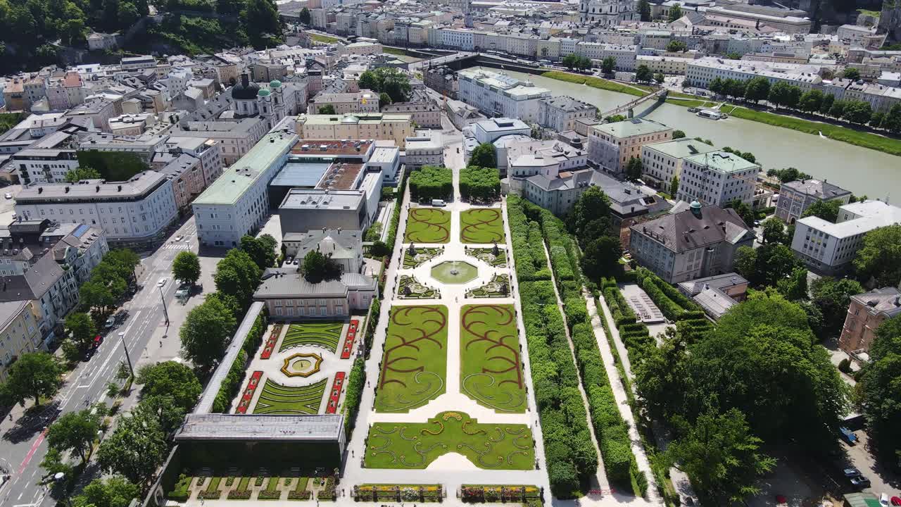 Mirabell Gardens, Salzburg Fortress in bright summer light, wide aerial shot, 4K