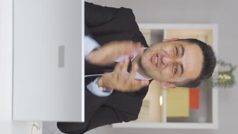 Vertical-video-of-Home-office-worker-man-looking-at-camera-clapping-and-getting-excited.