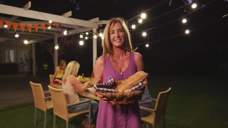 Senior-woman-holding-food-basket-outdoors