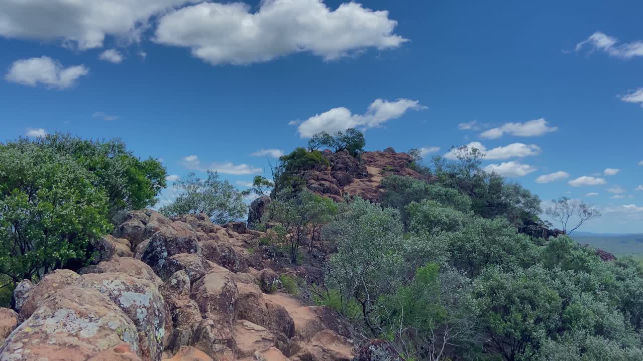 Smooth panning shot looking out over the Glasshouse Mountains from the summit of Mount Ngungun