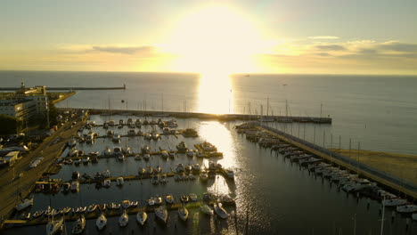 Bright-Sunlight-Reflection-At-The-Calm-Water-Of-GdaÅ„sk-Bay-With-Vessels-Moored-By-The-Baltic-Coast-In-Gdynia-Port-City,-Poland