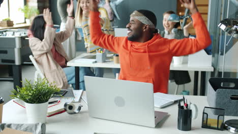 happy and energetic office team celebrating