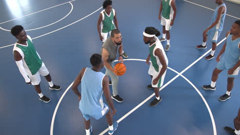 multiracial male basketball players entering gym, beginning game and players playing basketball
