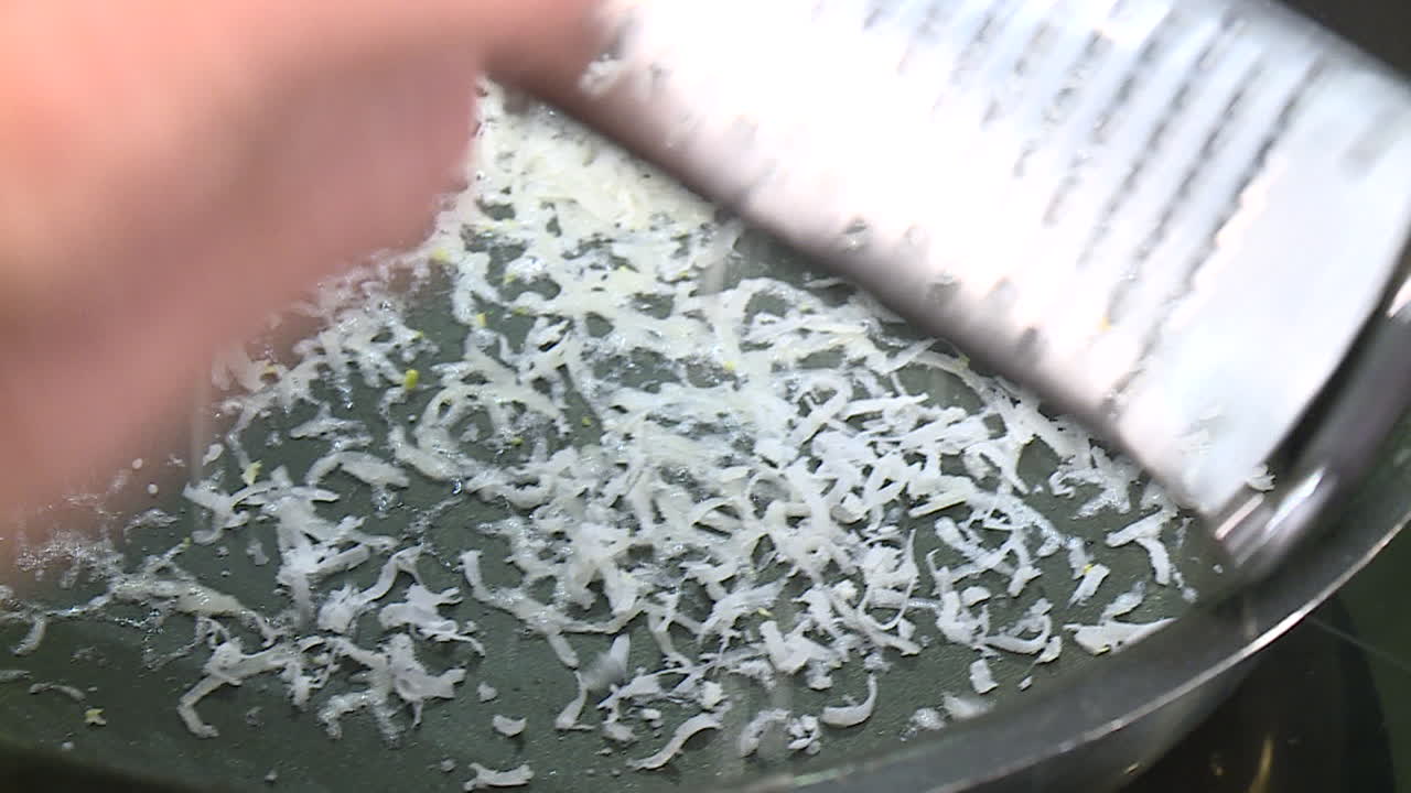 Shredding cheese in a pan