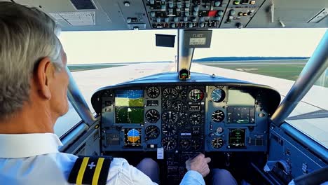 a pilot in the cockpit of a small plane during takeoff