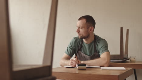 middle-aged waiter writing explanatory report