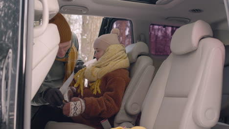 side view of a girl sitting in the back seat of a car 1