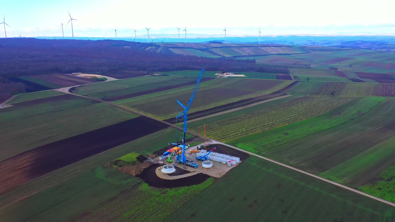 건설 중인 풍력 터빈이 있는 농장의 탁 트인 전망 - 드론 샷