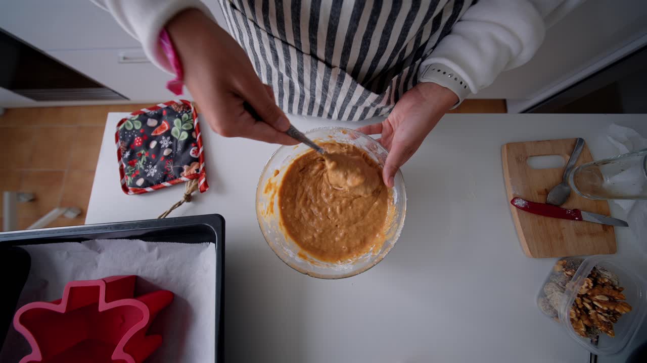 Close-up of Hands Mixing Batter in Glass Bowl for Baking