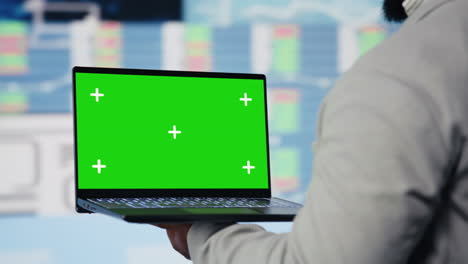 african american entrepreneur uses copy space on laptop and examines dashboards