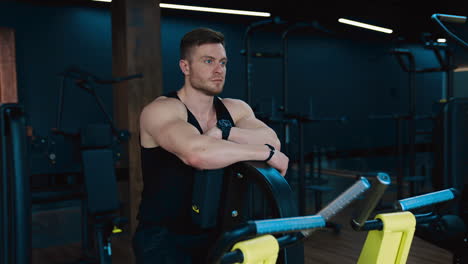 workout in the hardcore gym. muscular athlete training in the modern gym