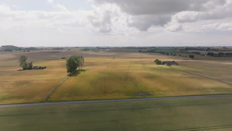 Cloudy-Sky-Over-Fields-Near-Asphalt-Road-Near-Gunnar-Colleges-Farm-Shop-In-Hammenhog,-Sweden