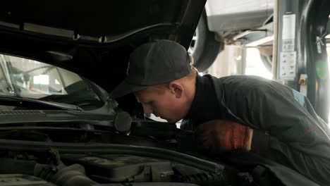 mechanic inspecting car engine