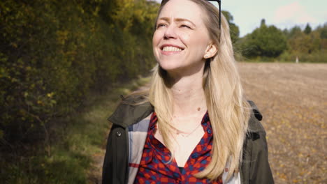 woman smiling on a path in the countryside