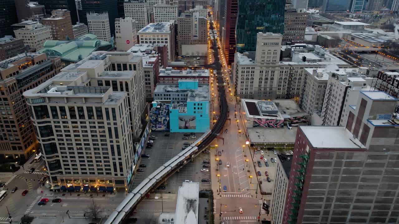 Aerial tracking overview of trains in gloomy South Loop, Chicago, Illinois, USA