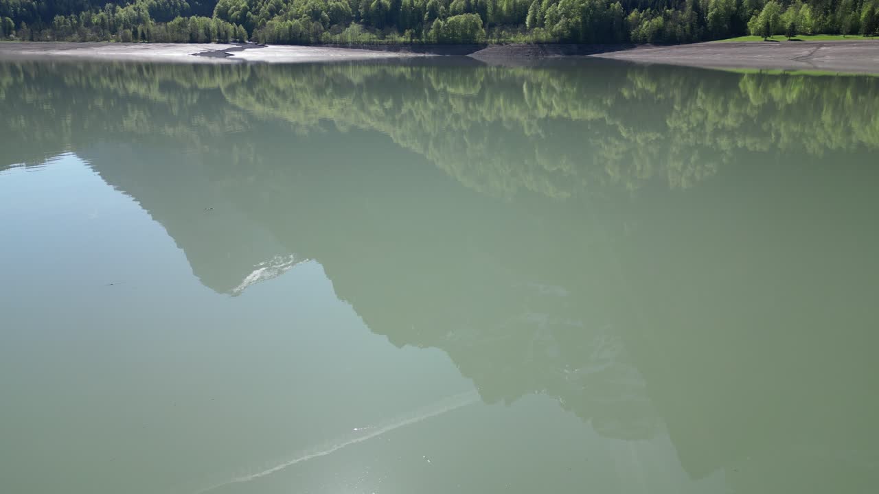 View of the reflection on the water surface of the Kl&ouml;ntalersee Glarus Kanton lake, Switzerland