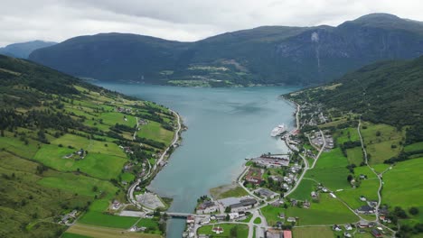 olden village and cruise ship in nordfjord, vestland, norway, scandinavia - aerial circling