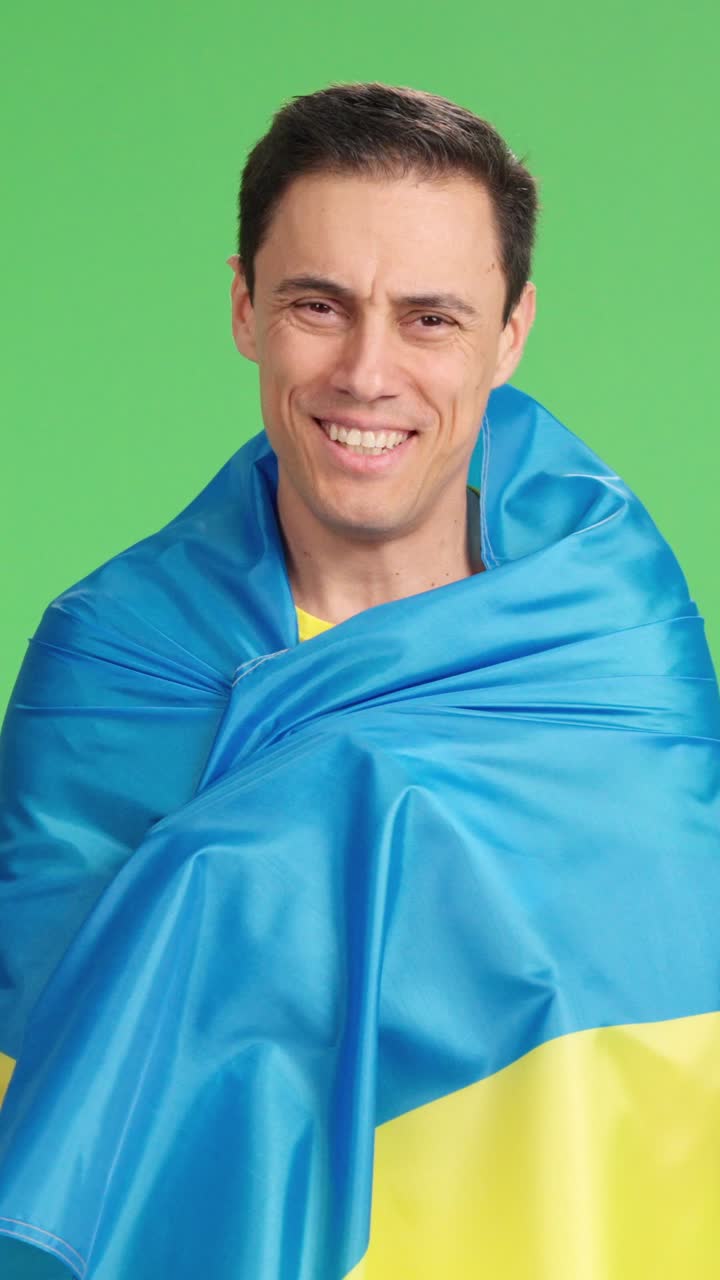 Ukrainian fan celebrating with flag on green screen