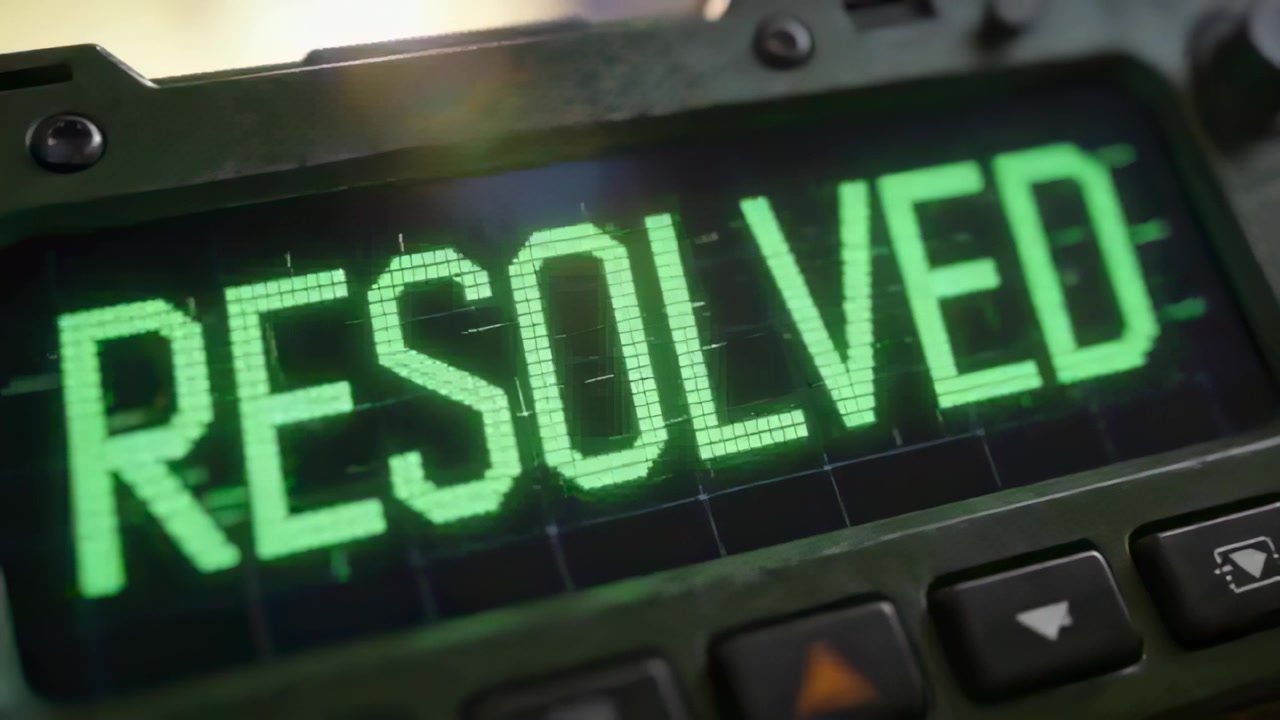 Displaying device screen on panel showing RESOLVED after status update, with bezel, orange button