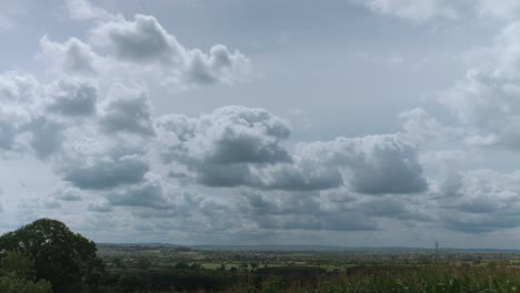 a vista of the wiltshire countryside with big clouds filmed from sandridge hill